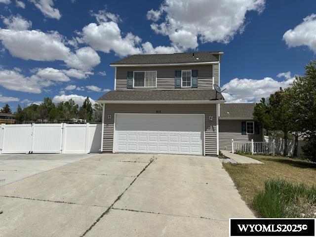 517 Archers Trl, Rock Springs, WY 82901 - traditional-style home featuring a gate, an attached garage, and driveway