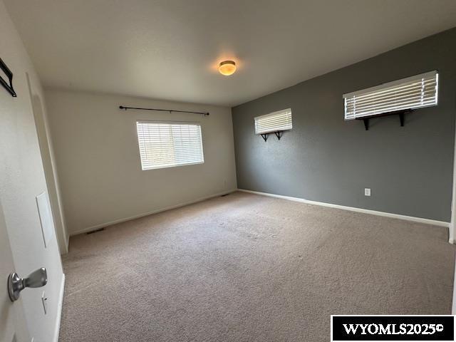 517 Archers Trl, Rock Springs, WY 82901 - spare room featuring carpet flooring and baseboards