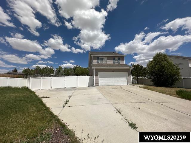 517 Archers Trl, Rock Springs, WY 82901 - view of side of home featuring concrete driveway and an attached garage