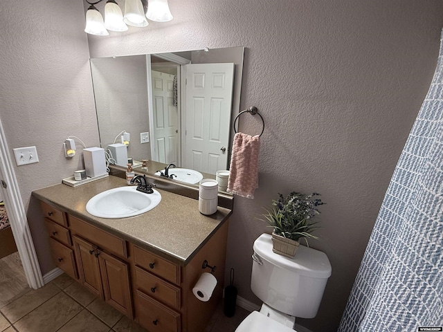 1765 New Mexico St, Green River, WY 82935 - bathroom featuring vanity, toilet, tile patterned floors, and a textured wall