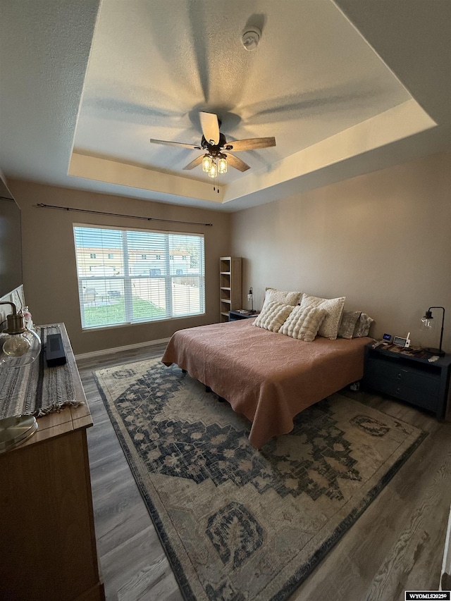 1765 New Mexico St, Green River, WY 82935 - bedroom featuring a raised ceiling, wood finished floors, and a ceiling fan