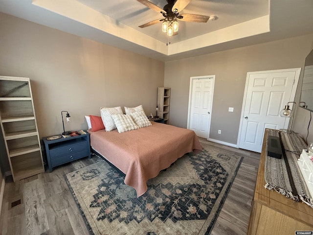 1765 New Mexico St, Green River, WY 82935 - bedroom featuring a raised ceiling, wood finished floors, baseboards, and ceiling fan