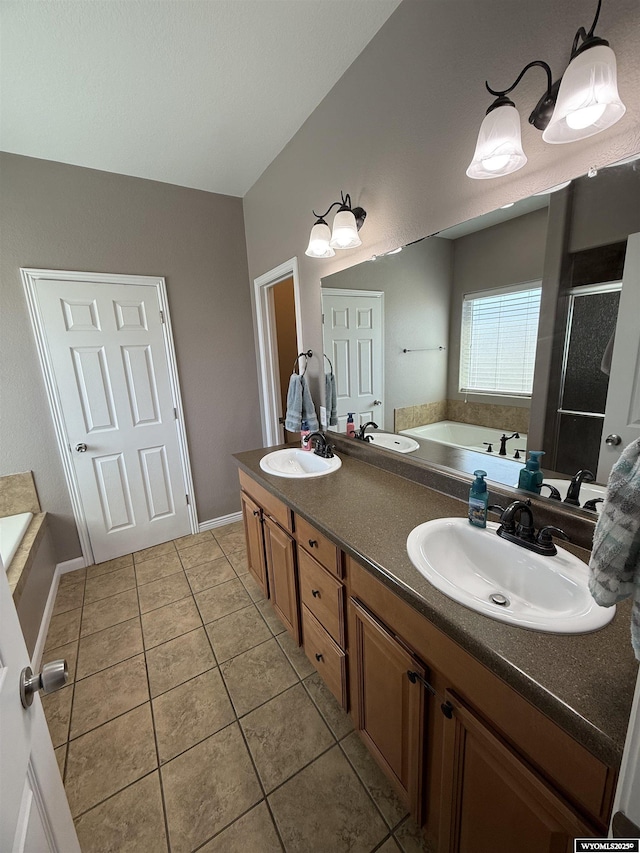 1765 New Mexico St, Green River, WY 82935 - full bath with tile patterned flooring, a bath, double vanity, a stall shower, and baseboards