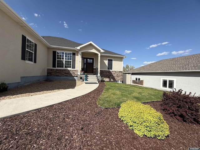 1765 New Mexico St, Green River, WY 82935 - view of front of property featuring stucco siding, a front yard, and stone siding