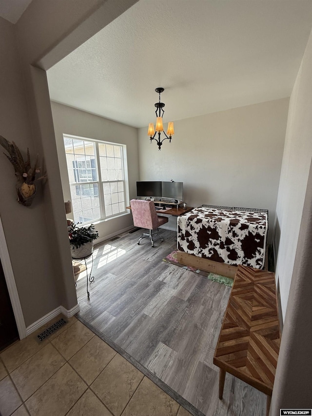 1765 New Mexico St, Green River, WY 82935 - tiled bedroom with a chandelier, an office area, and baseboards