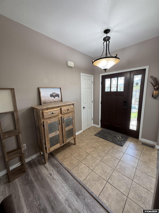 1765 New Mexico St, Green River, WY 82935 - foyer with baseboards, a textured ceiling, and light tile patterned flooring