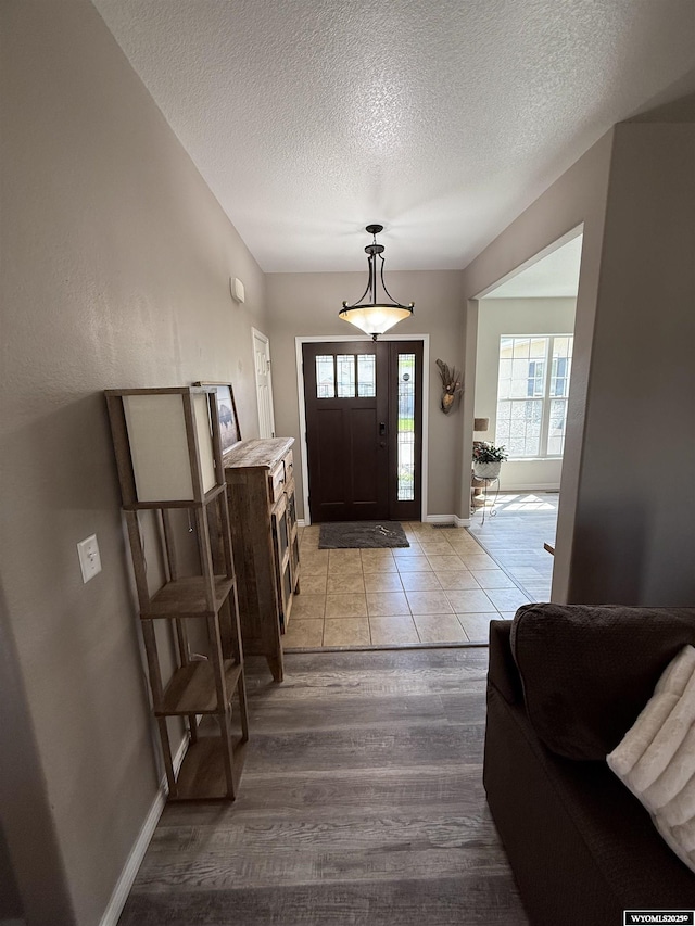 1765 New Mexico St, Green River, WY 82935 - foyer entrance featuring a textured ceiling, light wood-style floors, and baseboards