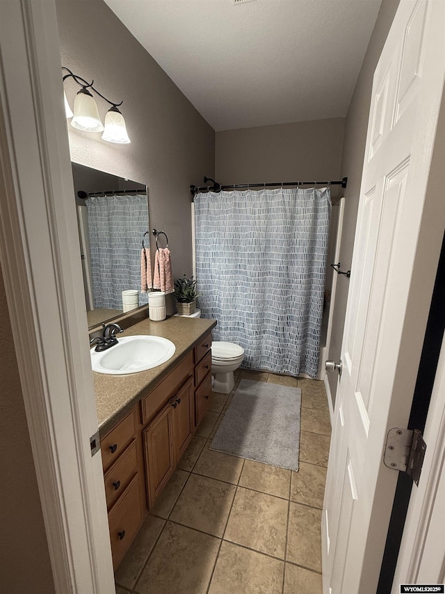 1765 New Mexico St, Green River, WY 82935 - full bath featuring vanity, toilet, and tile patterned floors