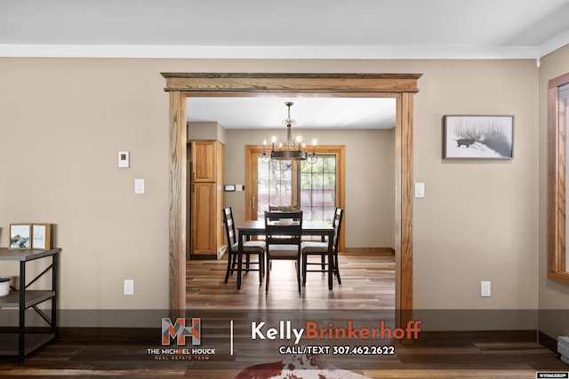 5411 S Oak St, Casper, WY 82601 - dining area featuring a chandelier, wood finished floors, and baseboards