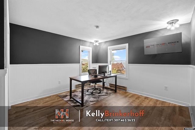 5411 S Oak St, Casper, WY 82601 - office area with a wainscoted wall, wood finished floors, baseboards, and baseboard heating
