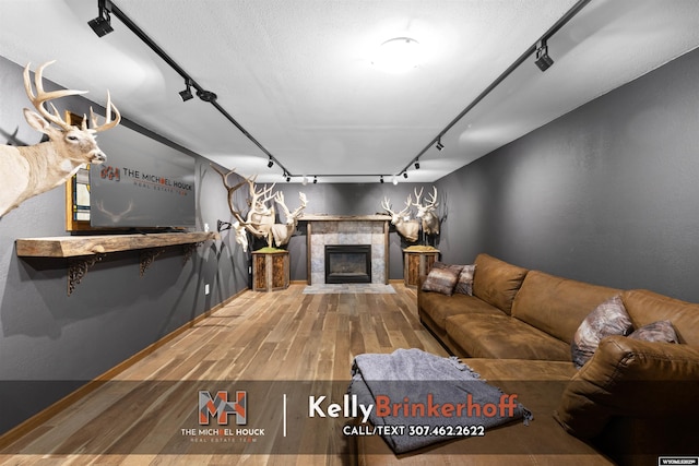 5411 S Oak St, Casper, WY 82601 - living room with rail lighting, wood finished floors, and a fireplace
