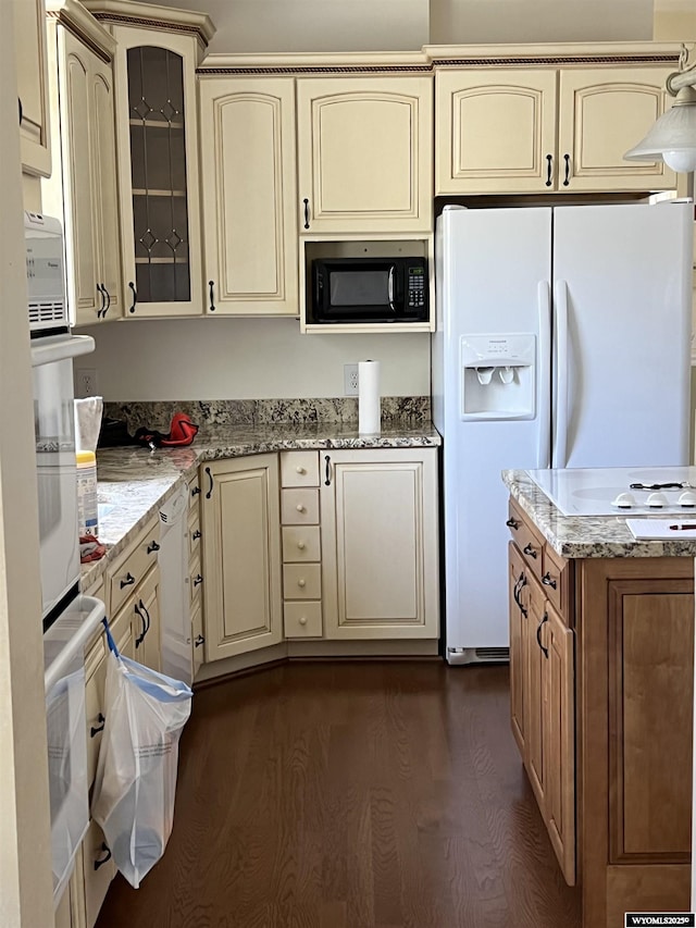 67 2nd Ave, Evanston, WY 82930 - kitchen featuring cream cabinetry, white appliances, dark wood-style flooring, glass insert cabinets, and light stone counters