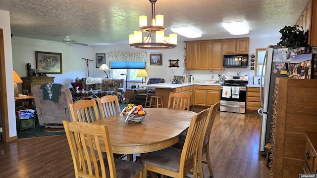 190 Ln 7, Thermopolis, WY 82443 - dining space with dark wood-type flooring, a textured ceiling, a ceiling fan, and a chandelier