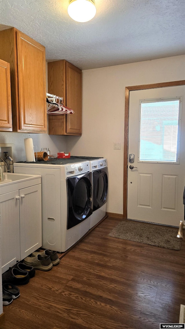 190 Ln 7, Thermopolis, WY 82443 - washroom with cabinet space, washer and dryer, dark wood finished floors, a textured ceiling, and baseboards