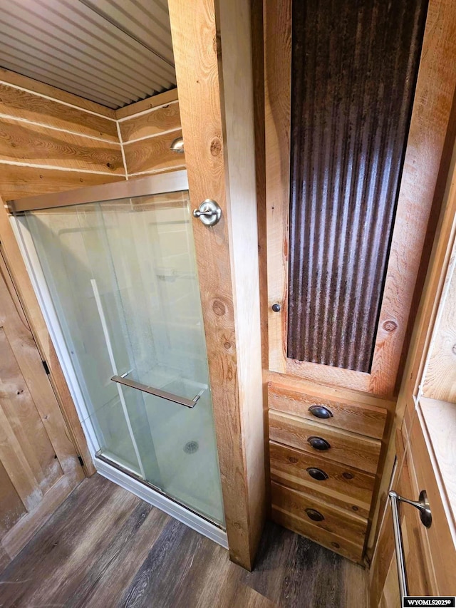 311 3rd St, Ten Sleep, WY 82442 - bathroom featuring wood finished floors and a shower stall
