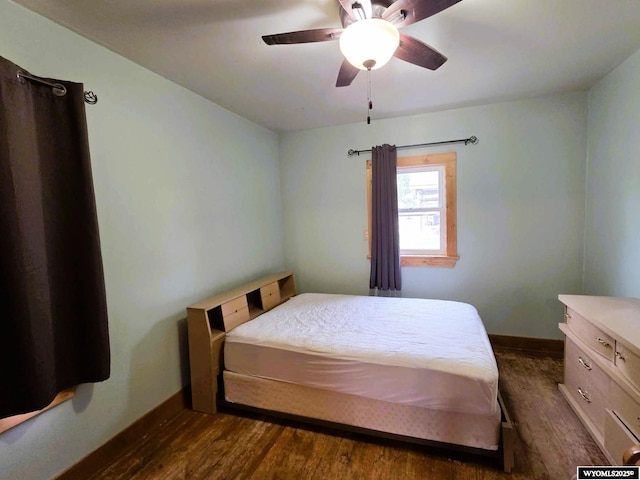 311 3rd St, Ten Sleep, WY 82442 - bedroom with dark wood-type flooring, baseboards, and a ceiling fan