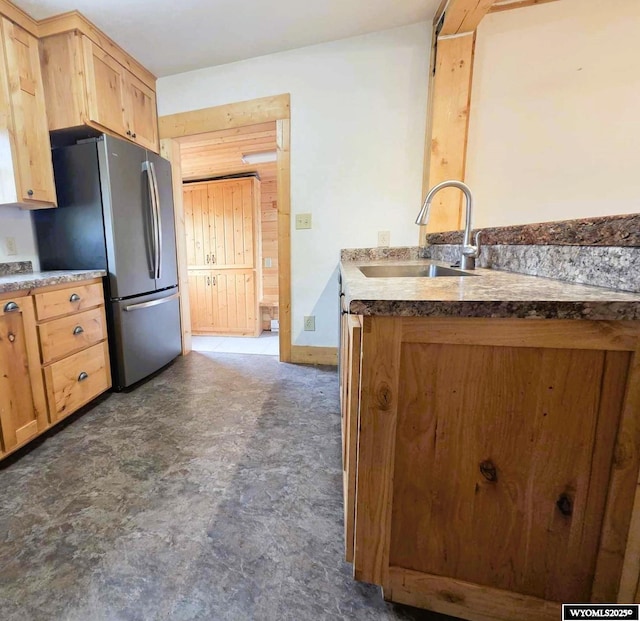311 3rd St, Ten Sleep, WY 82442 - kitchen with a sink, freestanding refrigerator, and light brown cabinetry