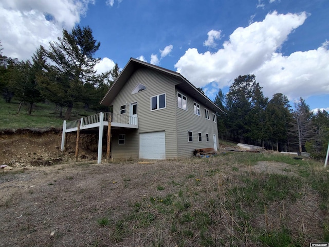 8 Lookout Ln, Dubois, WY 82513 - view of side of home with an attached garage and a deck