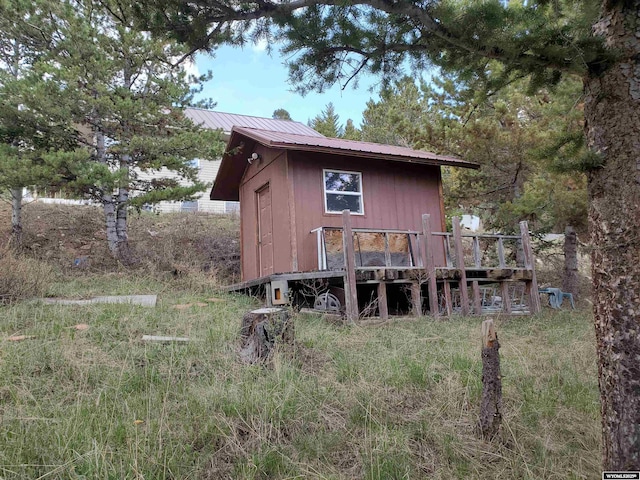 8 Lookout Ln, Dubois, WY 82513 - rear view of property with metal roof, a deck, and an outdoor structure