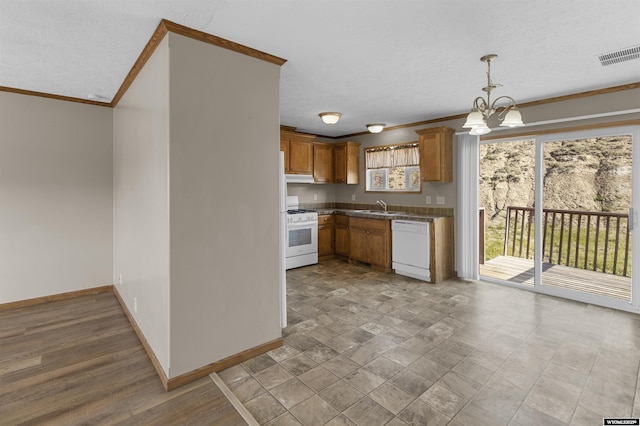 1673 Troy, Kemmerer, WY 83101 - kitchen featuring white appliances, a sink, crown molding, a chandelier, and baseboards