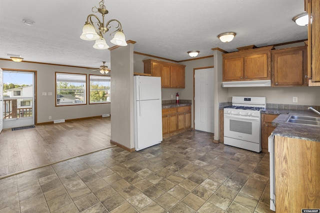 1673 Troy, Kemmerer, WY 83101 - kitchen with white appliances, under cabinet range hood, a sink, crown molding, and brown cabinets