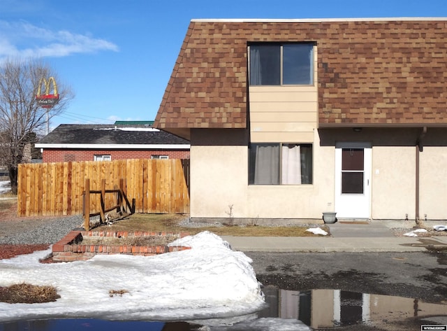 1809 Mountain View Dr, Cody, WY 82414 - view of front of house with a shingled roof and stucco siding