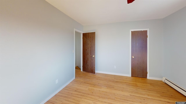 1809 Mountain View Dr, Cody, WY 82414 - unfurnished room with a baseboard radiator, light wood-type flooring, and baseboards
