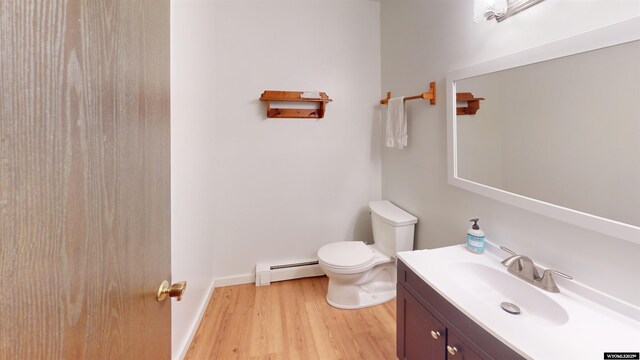 1809 Mountain View Dr, Cody, WY 82414 - bathroom featuring a baseboard heating unit, toilet, wood finished floors, and vanity