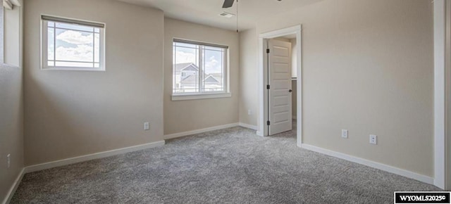 827 Dusty Ter, Mills, WY 82604 - unfurnished bedroom with multiple windows, carpet flooring, baseboards, and a ceiling fan