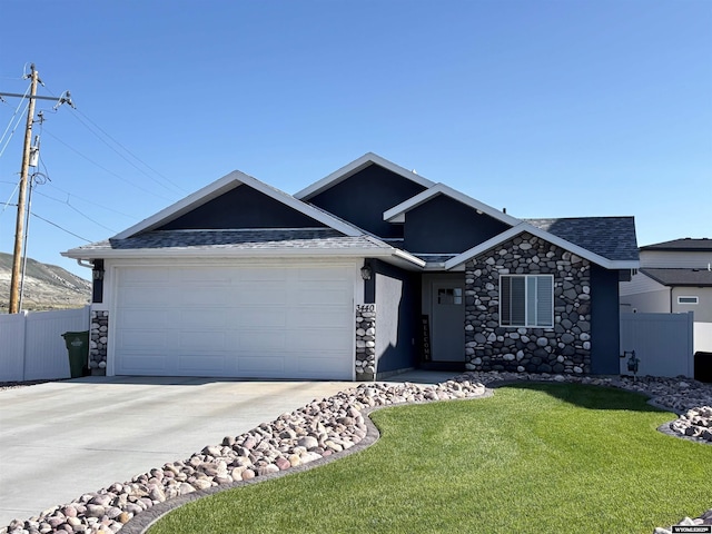 3440 Summit, Rock Springs, WY 82901 - view of front facade featuring an attached garage, stone siding, concrete driveway, and roof with shingles
