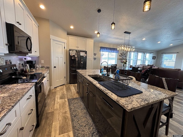 3440 Summit, Rock Springs, WY 82901 - kitchen with black appliances, healthy amount of natural light, light wood-type flooring, an island with sink, and recessed lighting