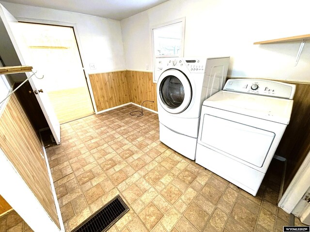 314 S Labarge St, La Barge, WY 83123 - laundry room with washer and dryer, a wainscoted wall, wooden walls, and brick patterned flooring
