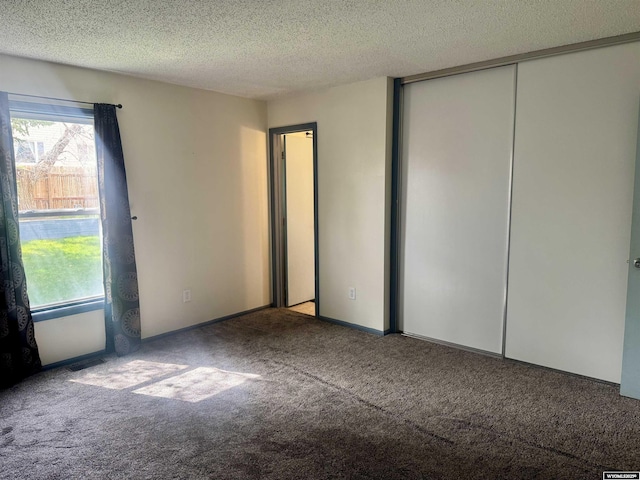 2318 Inverness Blvd, Rawlins, WY 82301 - unfurnished bedroom with carpet flooring, multiple windows, a textured ceiling, and a closet