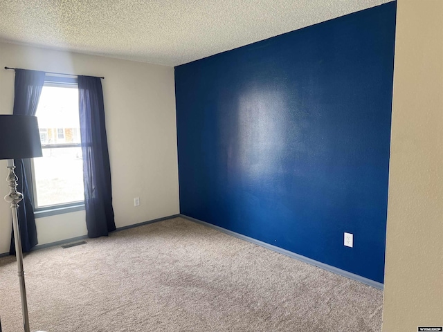 2318 Inverness Blvd, Rawlins, WY 82301 - carpeted spare room with a textured ceiling and baseboards