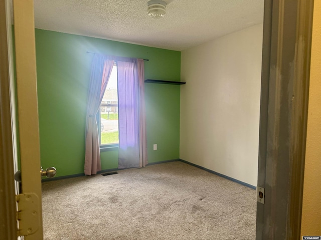 2318 Inverness Blvd, Rawlins, WY 82301 - spare room with carpet, a textured ceiling, and baseboards