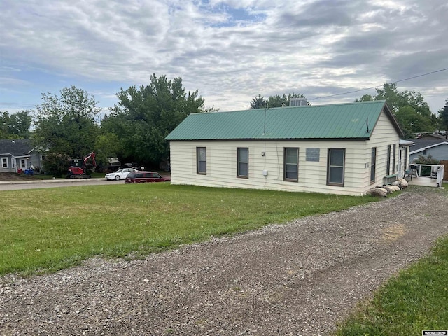 195 W Gatchell, Buffalo, WY 82834 - view of front of home with metal roof, a front lawn, driveway, and cooling unit