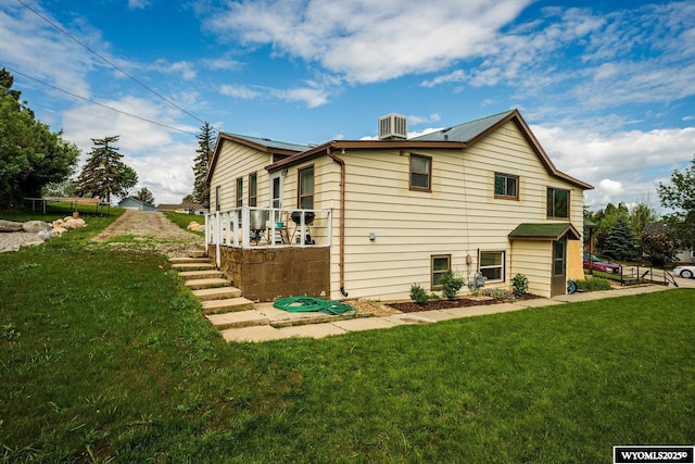 195 W Gatchell, Buffalo, WY 82834 - back of property with a lawn and central AC unit