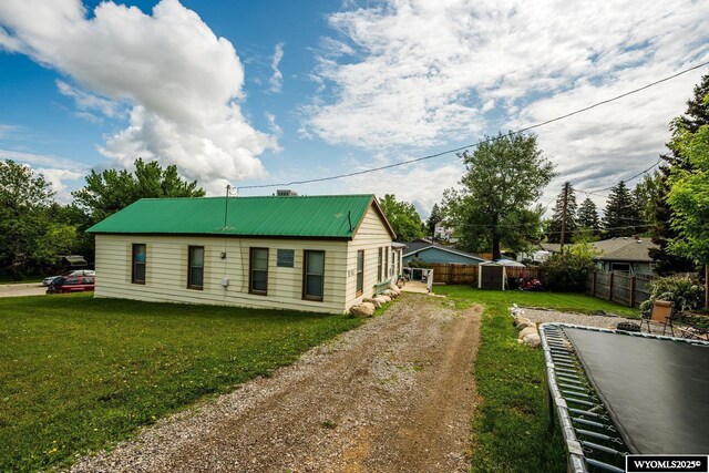 195 W Gatchell, Buffalo, WY 82834 - rear view of property featuring driveway and metal roof