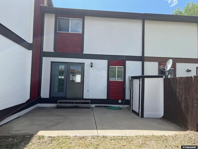 1821 Edinburgh St, Rawlins, WY 82301 - rear view of house with stucco siding, a patio area, and french doors