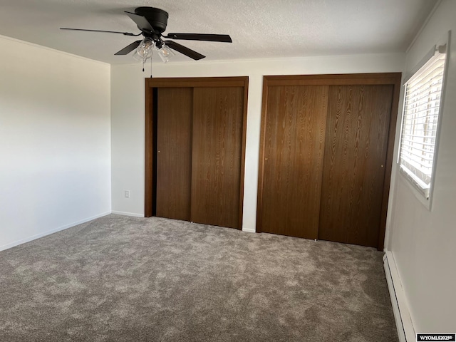 1821 Edinburgh St, Rawlins, WY 82301 - unfurnished bedroom featuring multiple closets, carpet, baseboard heating, and ceiling fan
