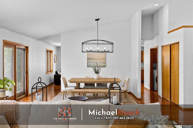 2001 Newport, Casper, WY 82609 - dining area with a chandelier, wood finished floors, baseboards, washer / clothes dryer, and a towering ceiling