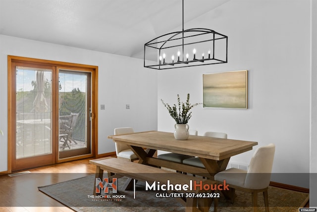 2001 Newport, Casper, WY 82609 - dining area with baseboards, wood finished floors, vaulted ceiling, and a chandelier