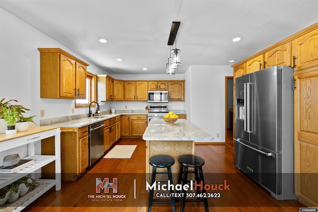 2001 Newport, Casper, WY 82609 - kitchen featuring stainless steel appliances, a sink, a kitchen island, light stone counters, and recessed lighting