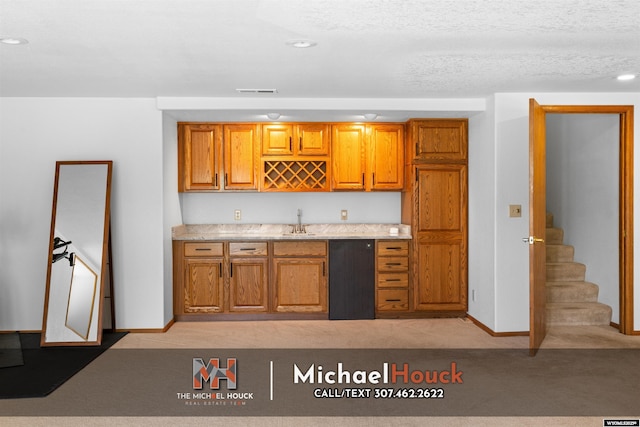 2001 Newport, Casper, WY 82609 - kitchen with a sink, brown cabinets, dishwasher, recessed lighting, and baseboards