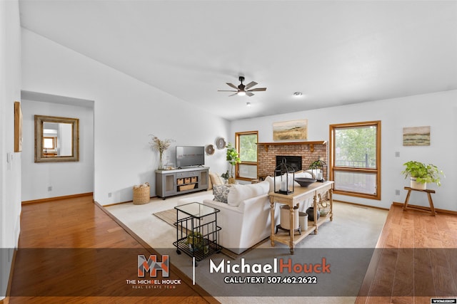 2001 Newport, Casper, WY 82609 - living room with a fireplace, a ceiling fan, wood finished floors, baseboards, and lofted ceiling