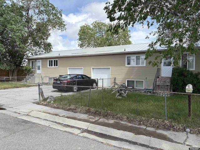 808 E Adams Ave, Riverton, WY 82501 - view of front of property featuring a garage, driveway, and metal roof