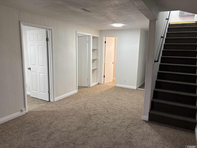 808 E Adams Ave, Riverton, WY 82501 - basement with stairs, carpet, a textured ceiling, and baseboards