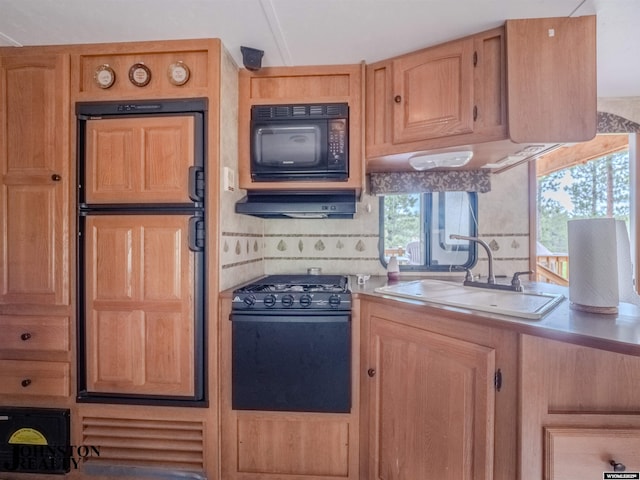 2921 Esterbrook Rd, Esterbrook, WY 82633 - kitchen featuring black appliances, under cabinet range hood, light countertops, a sink, and tasteful backsplash