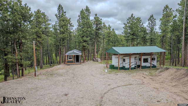2921 Esterbrook Rd, Esterbrook, WY 82633 - view of outbuilding with a view of trees, driveway, and a detached carport