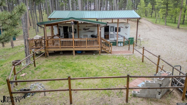 2921 Esterbrook Rd, Esterbrook, WY 82633 - view of front facade featuring metal roof, a wooden deck, and a wooded view